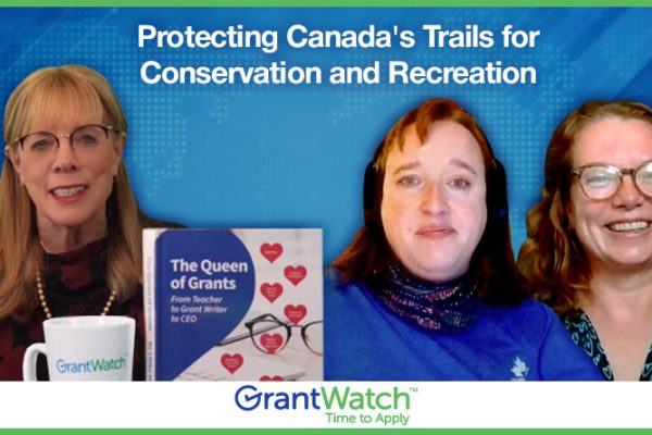 Three women from Grant Finders discuss protecting Canada’s trails for conservation and recreation. A copy of the book “The Queen of Grants: From Teacher to Grant Writer to CEO” is visible on the table.